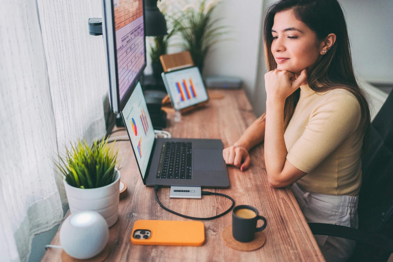 Woman working at home talks to virtual assistant