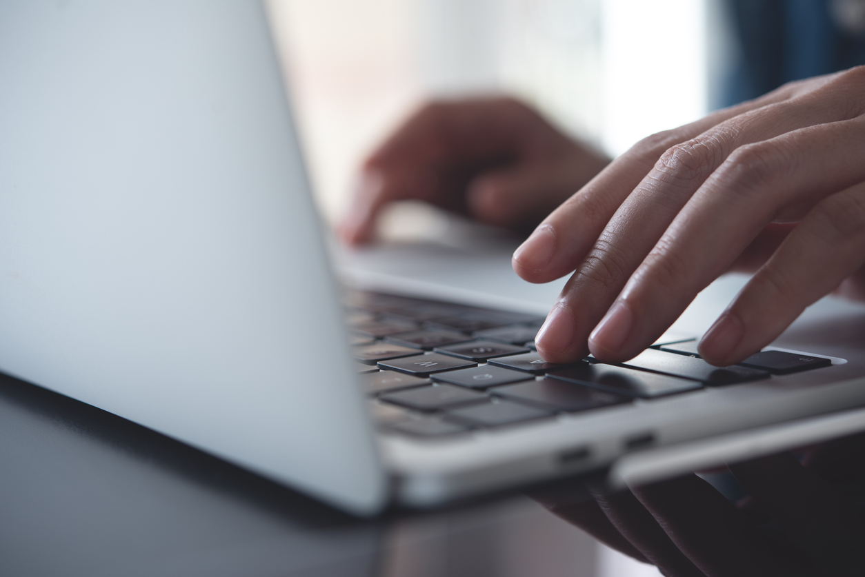 Close up of business woman hands typing on laptop keyboard on table, online working from home office, searching the information on internet network, e-learning, telecommuting concept